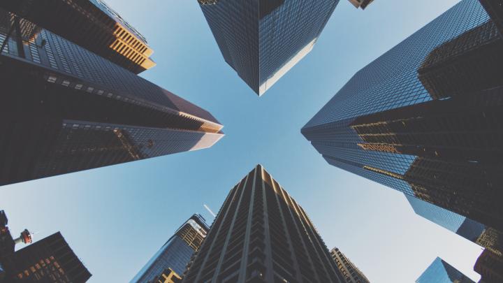 ground view of tall skyscrapers on a clear day